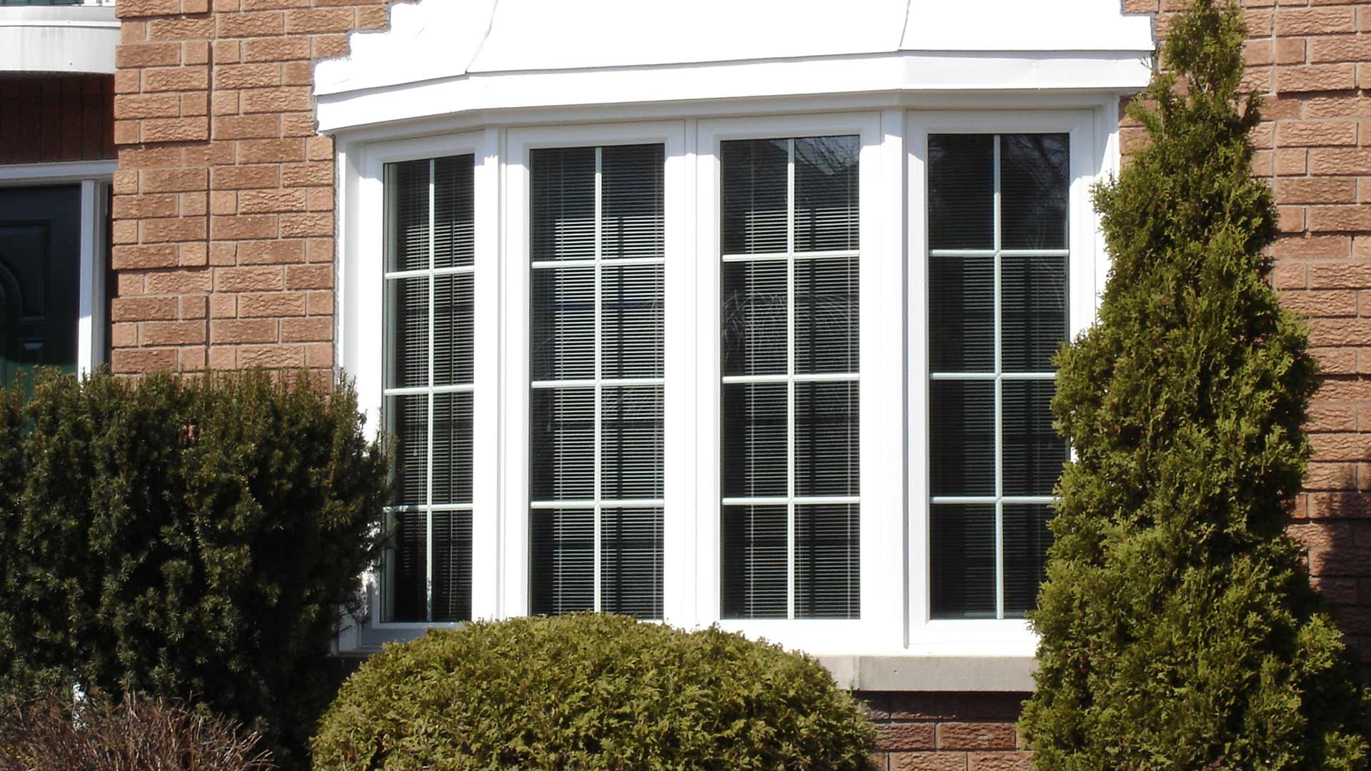The front of a house with a window with grilles.