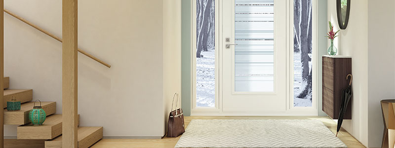 An interior view of a white front door with double sidelites on a winter day
