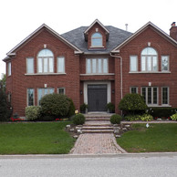 symmetrical brick home with shaped and casement windows