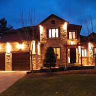 luxury home lit up at night