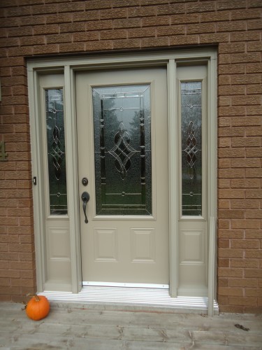 tan steel door with tall windows on either side