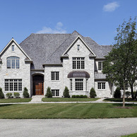 grey stone home with brown front door
