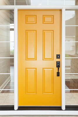 Sleek, yellow steel entry door with transom and double sidelites