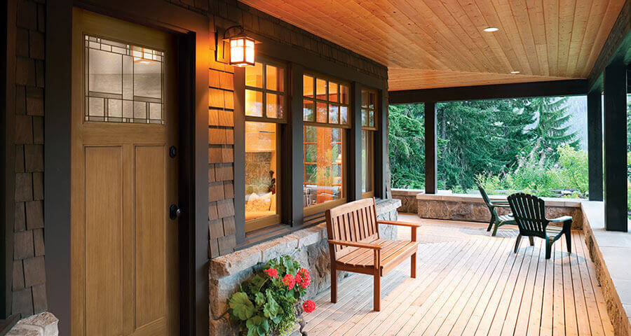 cabin replacement windows and a modern wooden door