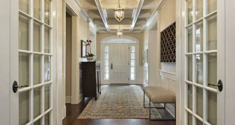 A photo of French doors opened leading into a hallway