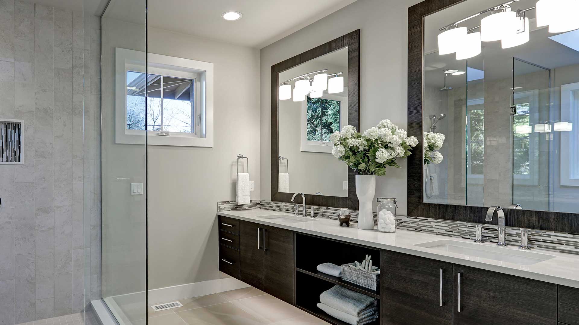 Modern renovated bathroom with a small awning window.