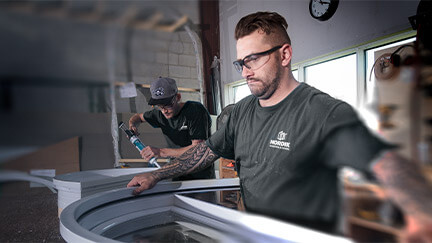 A window maker putting together a custom window.