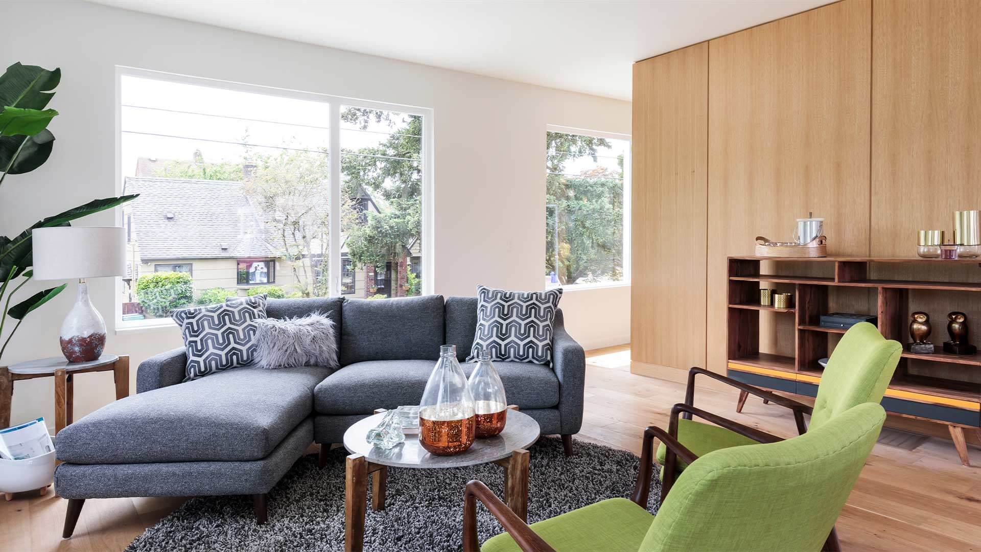 A modern living room with high-end furniture and plants.