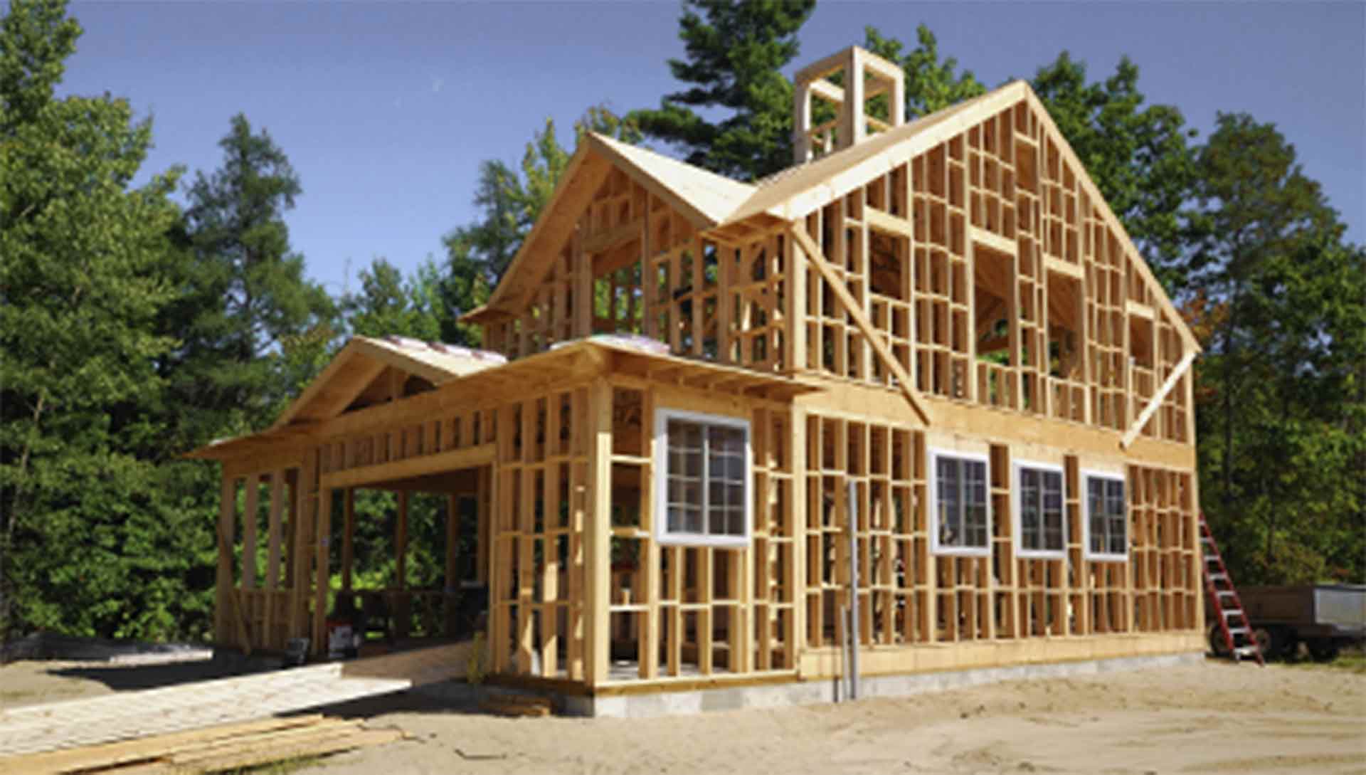 A photo of a house that has been framed, ready for installation of windows and doors.