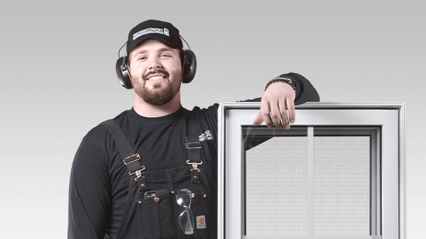 An installer leaning on a window.