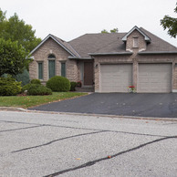 tan home with two garage doors