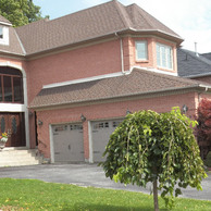 beautiful luxury home with three garage doors and double entry doors