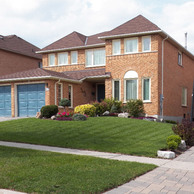 brick home with green garage doors