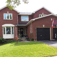 red brick home with black garage doors