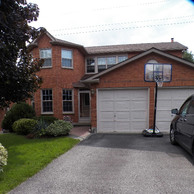 brick home with white garage doors