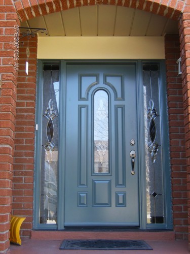 green steel entry door in archway