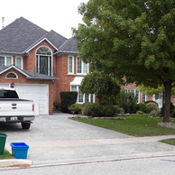 brick home with various types of windows with white trim