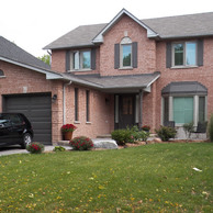 brick home with brown shutters and doors