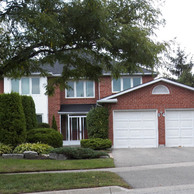 red brick home with white accent windows and doors