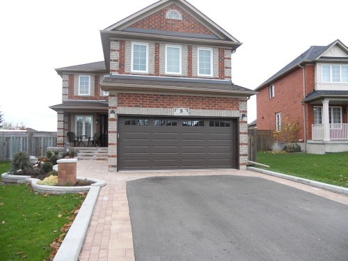 dark brown garage door with view of entire house