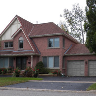 luxury red brick hom with various windows